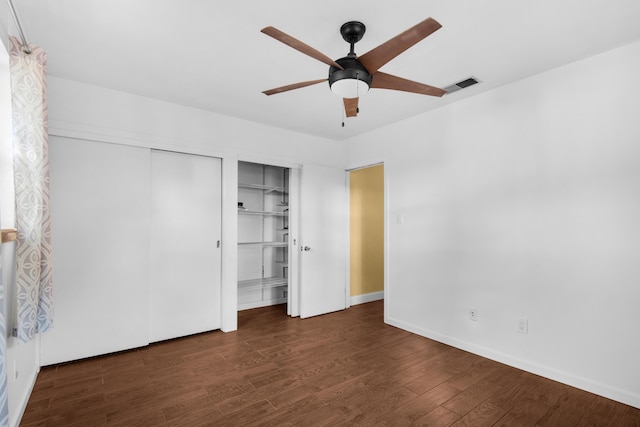 unfurnished bedroom featuring dark hardwood / wood-style floors and ceiling fan