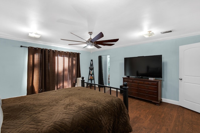 bedroom featuring dark hardwood / wood-style flooring, ceiling fan, and crown molding