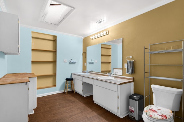 bathroom with toilet, vanity, wood-type flooring, and ornamental molding