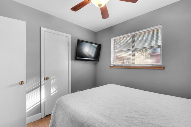 bedroom with light wood-type flooring and ceiling fan