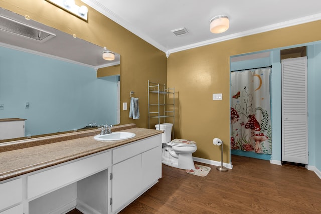 bathroom featuring walk in shower, toilet, hardwood / wood-style flooring, vanity, and ornamental molding