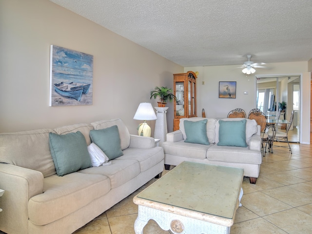 tiled living room featuring ceiling fan and a textured ceiling