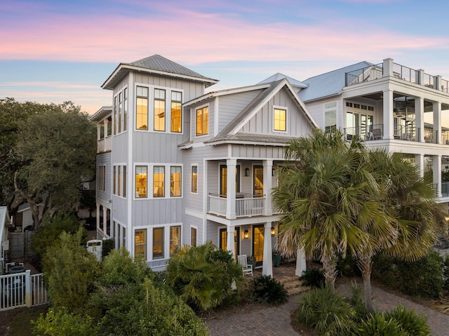 back house at dusk with a balcony