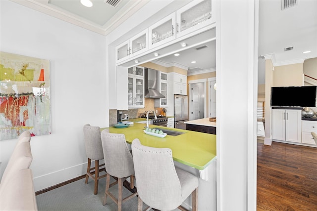 dining space featuring crown molding, dark wood-type flooring, and sink