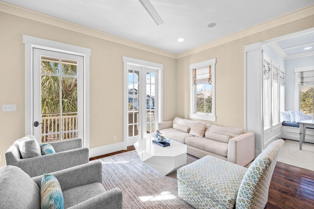 living room with dark hardwood / wood-style flooring and ornamental molding