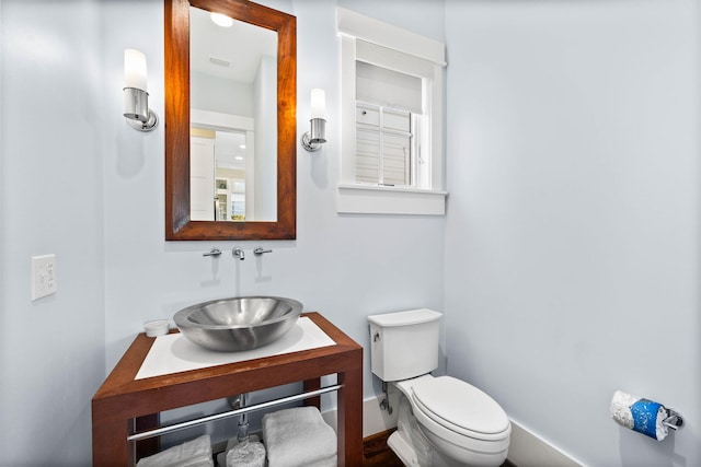 bathroom featuring vanity and toilet