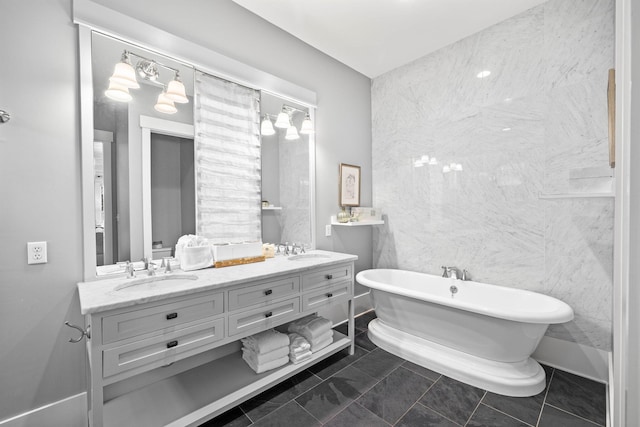 bathroom featuring tile patterned flooring, a bathtub, tile walls, and vanity