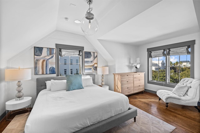 bedroom featuring hardwood / wood-style floors and lofted ceiling