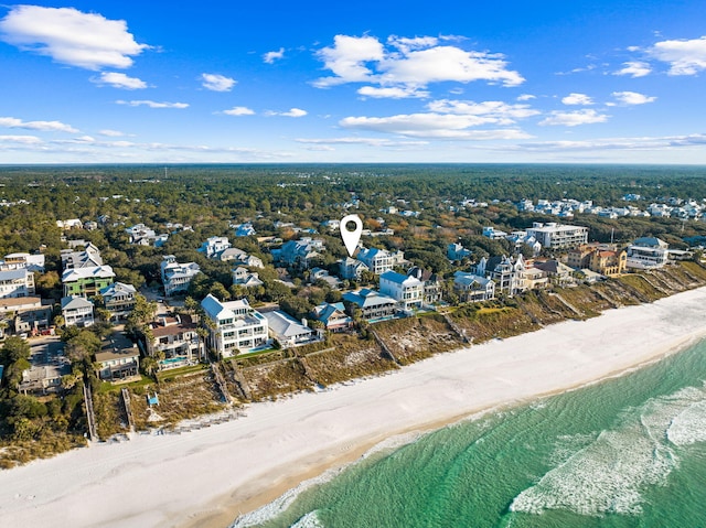 drone / aerial view featuring a water view and a beach view