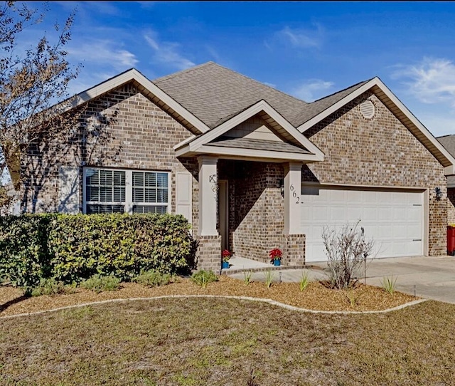 view of front of property with a garage and a front yard