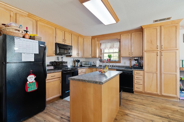 kitchen featuring a center island, light hardwood / wood-style flooring, a textured ceiling, light brown cabinets, and black appliances