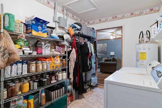 laundry area featuring water heater, light tile patterned flooring, ceiling fan, and independent washer and dryer