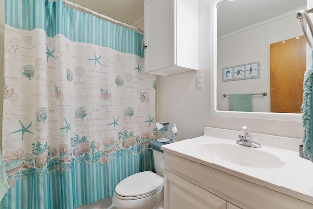 bathroom with vanity, ornamental molding, toilet, and walk in shower