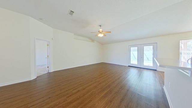 8679 High School Blvd, Navarre, FL 32566 - empty room featuring visible vents, baseboards, lofted ceiling, dark wood-type flooring, and french doors