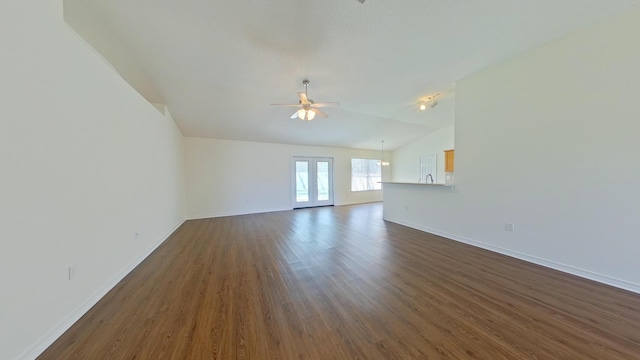 8679 High School Blvd, Navarre, FL 32566 - unfurnished living room with baseboards, vaulted ceiling, french doors, a ceiling fan, and dark wood-style flooring
