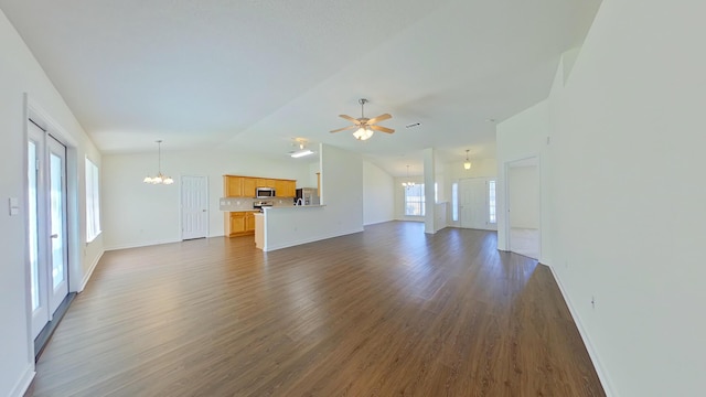 8679 High School Blvd, Navarre, FL 32566 - unfurnished living room with ceiling fan with notable chandelier, lofted ceiling, dark wood-style floors, and baseboards