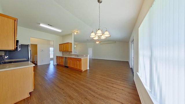 8679 High School Blvd, Navarre, FL 32566 - kitchen featuring a notable chandelier, a sink, open floor plan, stainless steel appliances, and lofted ceiling
