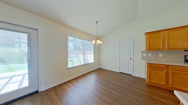 8679 High School Blvd, Navarre, FL 32566 - unfurnished dining area featuring vaulted ceiling, baseboards, dark wood-style flooring, and a chandelier