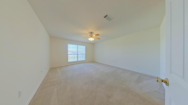 8679 High School Blvd, Navarre, FL 32566 - unfurnished room with baseboards, visible vents, ceiling fan, a textured ceiling, and light carpet