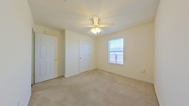 8679 High School Blvd, Navarre, FL 32566 - unfurnished bedroom with baseboards, light carpet, and ceiling fan