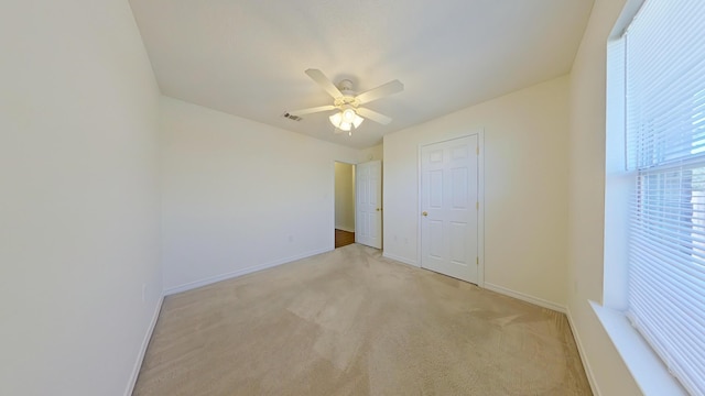 8679 High School Blvd, Navarre, FL 32566 - unfurnished bedroom with light carpet, visible vents, ceiling fan, and baseboards