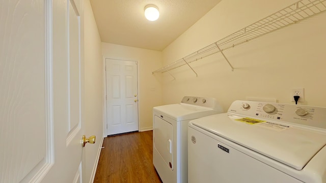 8679 High School Blvd, Navarre, FL 32566 - laundry room featuring dark wood-style floors, laundry area, washer and dryer, and a textured ceiling