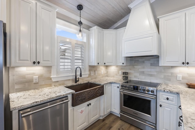 kitchen featuring sink, white cabinets, hanging light fixtures, and appliances with stainless steel finishes