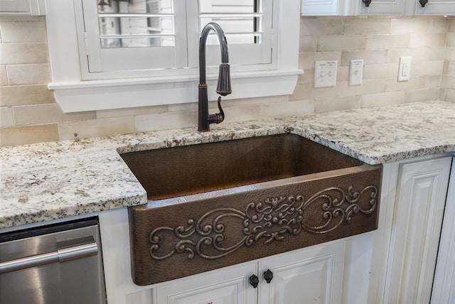 interior details with decorative backsplash and white cabinetry