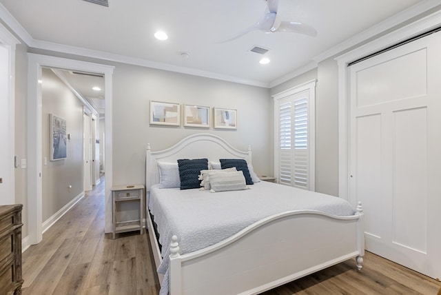 bedroom featuring hardwood / wood-style floors, ceiling fan, and crown molding