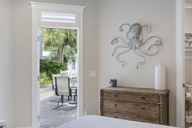 bedroom featuring access to exterior and light colored carpet