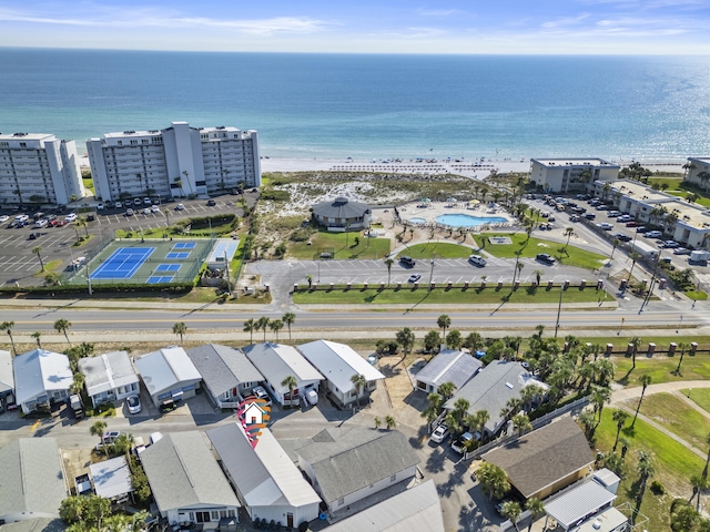 birds eye view of property featuring a water view and a beach view