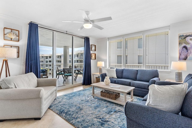 tiled living room featuring a textured ceiling, ceiling fan, and crown molding