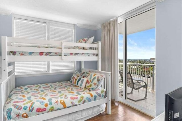 bedroom featuring access to outside, crown molding, and hardwood / wood-style floors