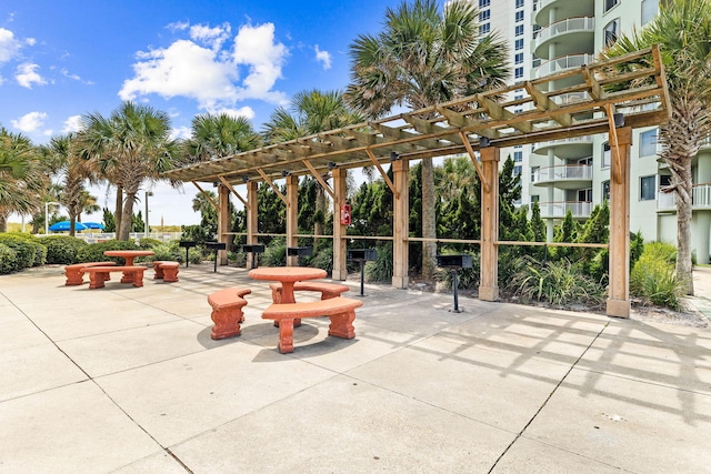 surrounding community with a pergola and a patio area