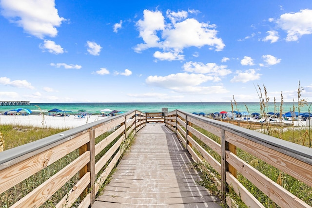 view of property's community featuring a beach view and a water view