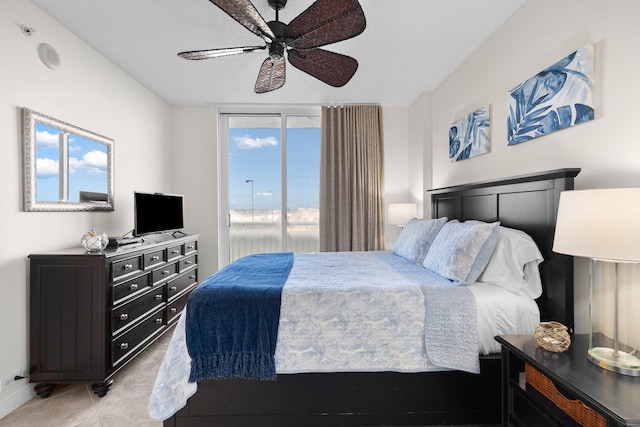 tiled bedroom with access to exterior and ceiling fan