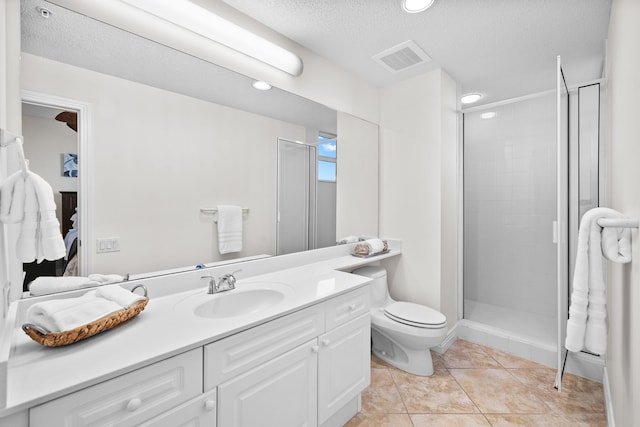 bathroom with vanity, tile patterned flooring, toilet, a textured ceiling, and a shower with shower door