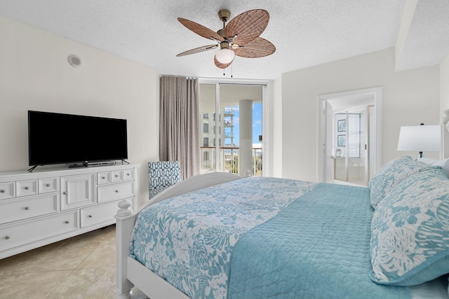 bedroom with a textured ceiling, connected bathroom, ceiling fan, and light tile patterned flooring