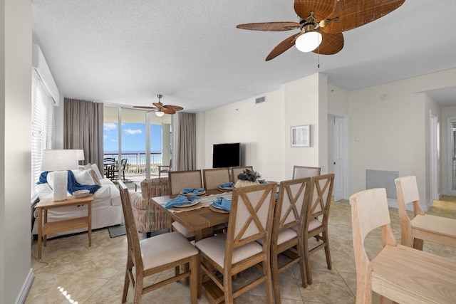 8501 Gulf Blvd Unit 3A, Navarre, FL 32566 - dining room featuring ceiling fan, floor to ceiling windows, a textured ceiling, and light tile patterned flooring