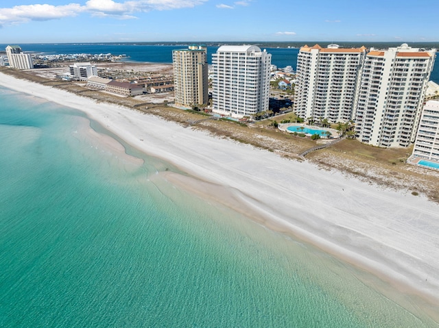 bird's eye view with a water view and a beach view