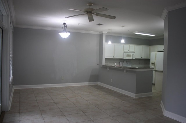 kitchen with white cabinets, pendant lighting, white appliances, and kitchen peninsula