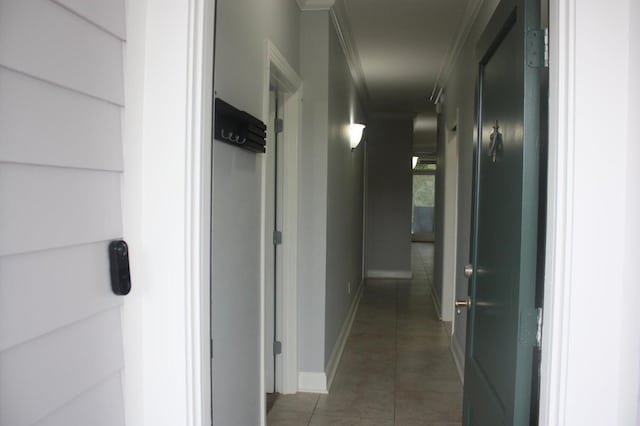 corridor with tile patterned flooring and ornamental molding