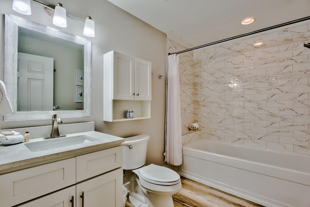 full bathroom featuring vanity, hardwood / wood-style flooring, toilet, and shower / bathtub combination with curtain