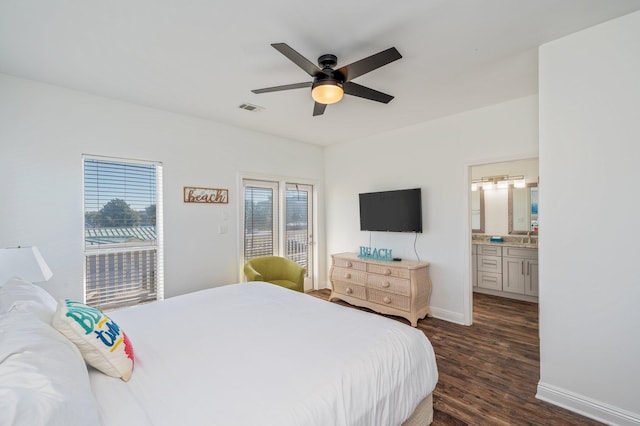 bedroom featuring ceiling fan, dark wood-type flooring, and ensuite bath