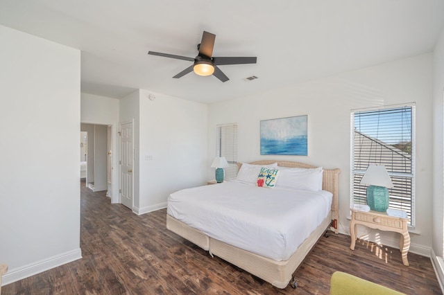 bedroom with dark hardwood / wood-style flooring and ceiling fan