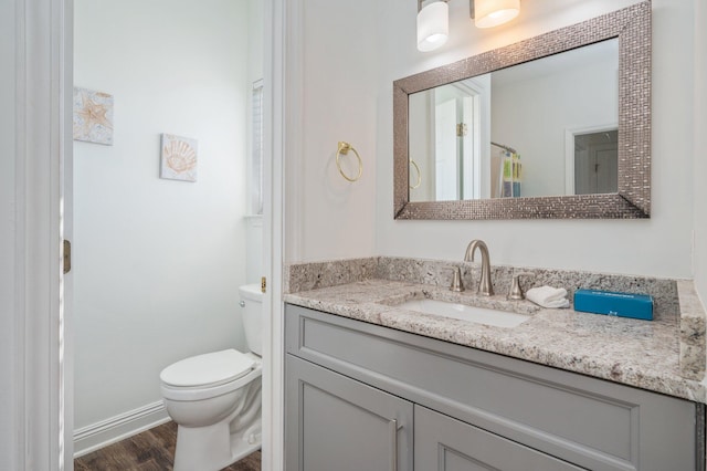 bathroom featuring hardwood / wood-style floors, vanity, and toilet