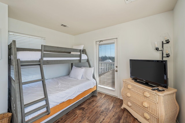 bedroom with dark wood-type flooring