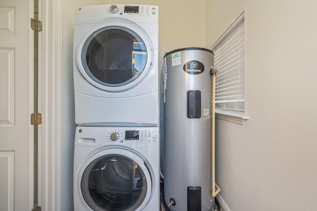 washroom with stacked washer / dryer and water heater