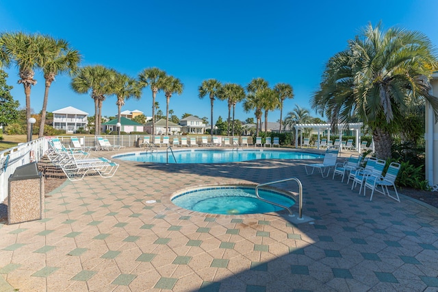 view of swimming pool with a patio area and a community hot tub