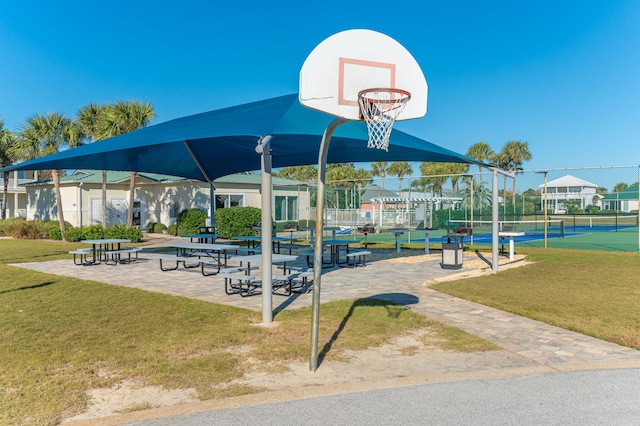 surrounding community with a yard, basketball court, and tennis court